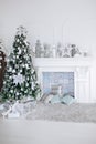 Christmas and New Year decorated white interior room with presents and New year tree and fireplace Royalty Free Stock Photo