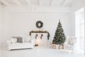 Christmas and New Year decorated white interior room with presents and New year tree and fireplace Royalty Free Stock Photo