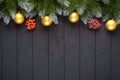 Christmas or New Year decoration background: fir-tree branches, colorful balls, candy cane on black background. Top view with copy Royalty Free Stock Photo