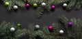 Christmas or New Year decoration background: fir-tree branches, colorful glass balls on black Royalty Free Stock Photo