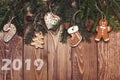 Christmas or New Year decoration background. 2019 New Year. Fir tree branches and gingerbread on wooden rustic background. Copy sp Royalty Free Stock Photo