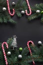 Christmas or New Year decoration background. Fir tree branches, spruce, candy, colorful balls on black background with copy space. Royalty Free Stock Photo