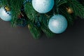 Christmas or New Year decoration background: fur-tree branches, colorful glass balls on black grunge background. Christmas composi Royalty Free Stock Photo