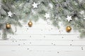 Christmas or New Year decoration background: fur-tree branches, colorful glass balls and glittering stars on white Royalty Free Stock Photo