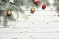 Christmas or New Year decoration background: fur-tree branches, colorful glass balls and glittering stars on white Royalty Free Stock Photo