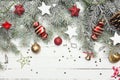 Christmas or New Year decoration background: fur-tree branches, colorful glass balls and glittering stars on white Royalty Free Stock Photo