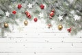 Christmas or New Year decoration background: fur-tree branches, colorful glass balls and glittering stars on white Royalty Free Stock Photo