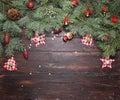 Christmas or New Year decoration background: fur-tree branches, colorful glass balls and glittering stars on wooden Royalty Free Stock Photo