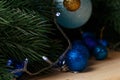 Christmas or New Year decoration background: fur-tree branches, colorful glass balls on wooden background. Royalty Free Stock Photo