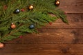 Christmas or New Year decoration background. Spruce branch decorated by the balls, on dark wooden  background Royalty Free Stock Photo