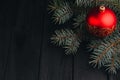 Christmas New Year decoration composition. Top view of fur-tree branches and balls frame on wooden background with place for your Royalty Free Stock Photo