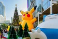 Christmas and New Year decoration design with Pikachu Pokemon theme, Japanese cartoon, with background of large Christmas tree in