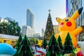 Christmas and New Year decoration design with Pikachu Pokemon theme, Japanese cartoon, with background of large Christmas tree in