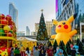 Christmas and New Year decoration design with Pikachu Pokemon theme, Japanese cartoon, with background of large Christmas tree in