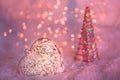 Glass heart on a snow and toned blurred pink background of glittering bokeh with glowing lights. Christmas decoration. Copy space Royalty Free Stock Photo