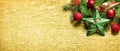 Christmas and new year decoration on golden textured background. Golden holiday banner layout with xmas ornamet and fir tree