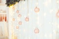 Christmas and New Year Decoration. Selective focus on Light pink glittering baubles ang garlands hanging on wall composition. Xmas Royalty Free Stock Photo