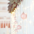 Christmas and New Year Decoration. Selective focus on Light pink glittering baubles ang garlands hanging on wall composition. Xmas Royalty Free Stock Photo