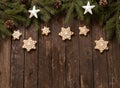 Christmas, New Year decoration with star shaped and winter holiday motives on top of evergreen branches and rustic wooden