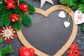 Christmas or New Year decorations background: a frame in the shape of a heart is surrounded by branches of a New Year tree Christm Royalty Free Stock Photo