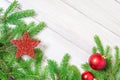 Christmas or new year decorations background: tree branches and wooden red Christmas toys in the form of stars and balls. Copy Royalty Free Stock Photo