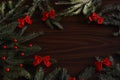 Christmas and New year decorations green fir branch and red ribbons top view on a wooden holiday background