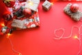 Christmas and New Year decorations mock up or flat lay on red background. Gifts, garland, snowman. Winter, New Years holidays conc Royalty Free Stock Photo