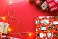 Christmas and New Year decorations mock up or flat lay on red background. Gifts, garland, snowman. Winter, New Years holidays conc Royalty Free Stock Photo