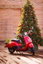 Christmas and New Year decorations, red motorcycle and beautiful tree with red balls Royalty Free Stock Photo