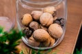 Christmas and New Year details in a photo studio. Nuts in a glass flask (1).