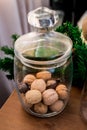 Christmas and New Year details in a photo studio. Nuts in a glass flask (2).