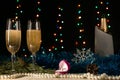 Christmas and New Year dinner of a couple with two glasses of champagne and a wedding ring. Marriage proposal concept. Pearls, tin Royalty Free Stock Photo