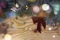 Christmas New Year eve background with fir tree and decoration on light wooden board glare of light Royalty Free Stock Photo