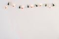 Christmas or new year feat lay. Greeting minimalistic stylish card. Lights with Christmas socks and Christmas tree-clothespins