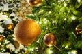 Christmas or New Year festive banner, golden christmas decorations glass balls, green pine branches, white snow and shiny lights Royalty Free Stock Photo