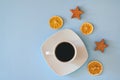 Christmas, New Year flat lay on blue background. Christmas decorations with dry spices, orange rings, cinnamon. Coffee Cup Royalty Free Stock Photo