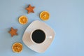 Christmas, New Year flat lay on blue background. Christmas decorations with dry spices, orange rings, cinnamon. Coffee Cup Royalty Free Stock Photo