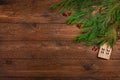 Christmas or New Year flat lay decoration background: cypress branches, wooden house, on dark wooden background