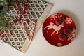Christmas and new year flat lay. Red deer plate and sugar apples, candy cane and red berries