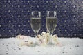 Christmas or New Year food and drink photography image using marshmallows shaped as snowman in snow with glasses of champagne