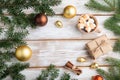 Christmas or New Year frame composition. Decorations, box, balls, fir and spruce branches, cup of coffee, on a white wooden Royalty Free Stock Photo