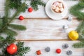 Christmas or New Year frame composition. Decorations, red balls, cones, fir and spruce branches, on a white wooden background. Top Royalty Free Stock Photo