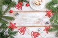 Christmas or New Year frame composition. Decorations, red stars, bells, cones, fir and spruce branches, on a white wooden Royalty Free Stock Photo