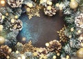 Christmas or New Year frame composition with  green snow fir branches, pine cones, golden snowflakes, Christmas balls on brown Royalty Free Stock Photo