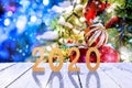 Christmas or new year frame or mockup for your project. 2020 fugures on white wooden against illuminated fairy christmas trees Royalty Free Stock Photo