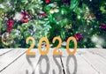 Christmas or new year frame or mockup for your project. 2020 fugures on white wooden against illuminated fairy christmas trees Royalty Free Stock Photo
