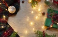 Christmas, New Year frame with Scottish tartan pattern and festive lights on the wooden background.