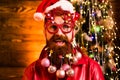 Christmas or New Year funny concept. Beard with bauble. Santa in barber shop. Merry christmas and happy new year. New