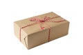 Christmas and New Year gift box wrapped in brown craft kraft paper with red and white baker's twine Royalty Free Stock Photo