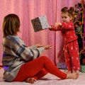 Christmas and New Year gifts, mom and daughter with gifts at home near the Christmas tree Royalty Free Stock Photo